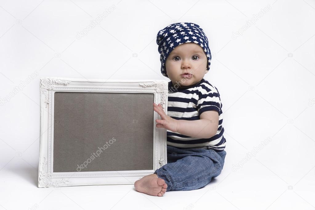 Cute baby holding a blank framed sign