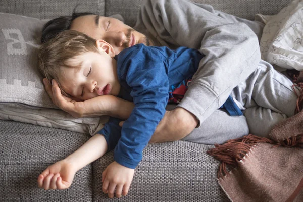 Vader en zoon slapen op de Bank — Stockfoto