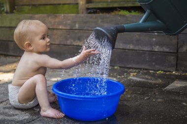 Beautiful baby playing with water
