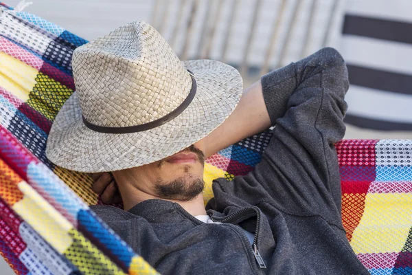 Hombre relajándose en una hamaca al atardecer — Foto de Stock