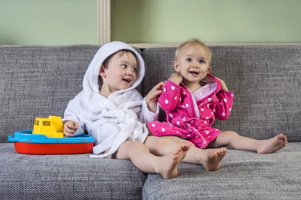 Cute siblings in bath robes — Stock Photo, Image
