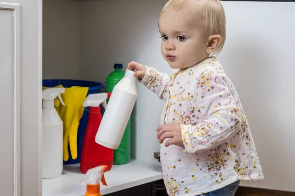 Mała dziewczynka gra z domowych środków czyszczących — Zdjęcie stockowe