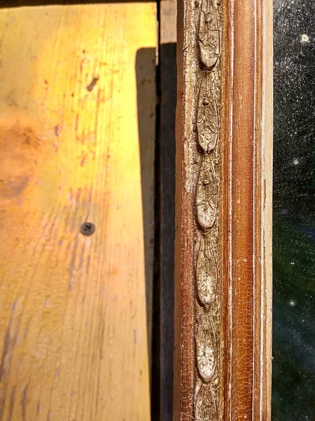 Patina on an old wooden hanging mirror frame