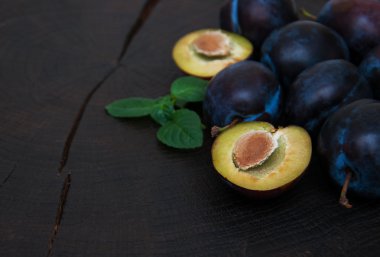 Fresh plums with green leaves
