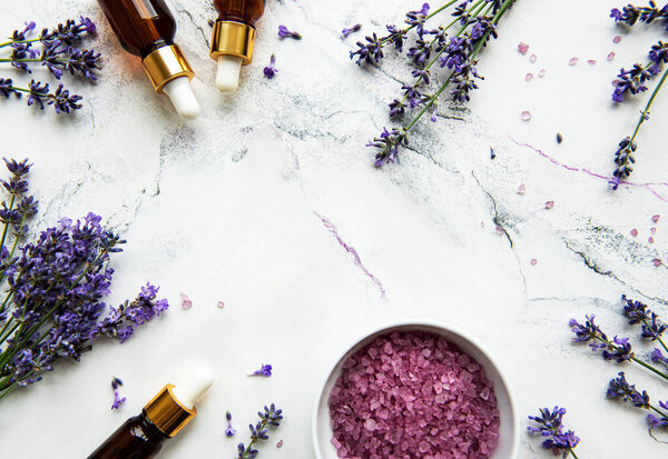 Natural herb cosmetic with lavender,  flatlay on white marble background,  top view