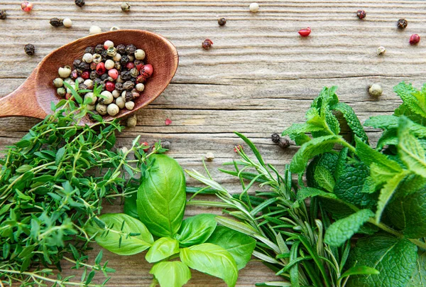 stock image Fresh herbs and spices on wooden background top view