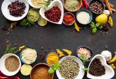 Siyah beton arka planda bir kasede çeşitli baharatlar. Üst görünüm kopyalama alanı.