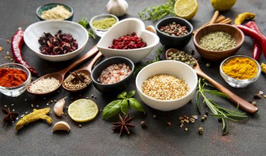 Siyah beton arka planda bir kasede çeşitli baharatlar. Üst görünüm kopyalama alanı.