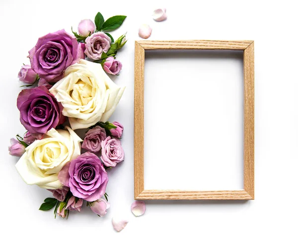 Framework from roses on white background. Flat lay.