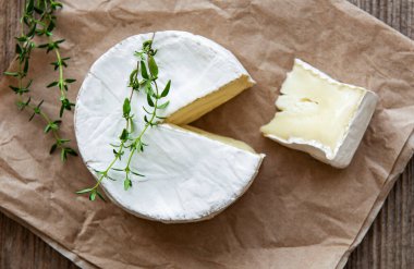 Camembert peyniri ve eski ahşap masada atıştırmalıklar.