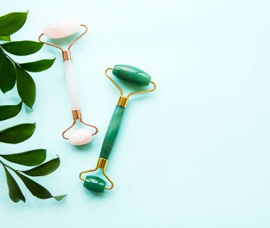 Pastel yeşil arka planda yüz masajı yeşili silindiri.