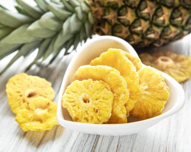 Kırsal ahşap zeminde ananas kurutulmuş halkalar.