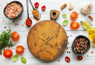 Ahşap mutfak aletleri, boş kesim tahtası ve baharatlar. Yemek pişirme şablonu. Kopyalama alanı olan üst görünüm. Düz yatıyordu