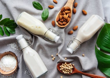 Bottles with different plant milk - soy, almond and oat milk. clipart