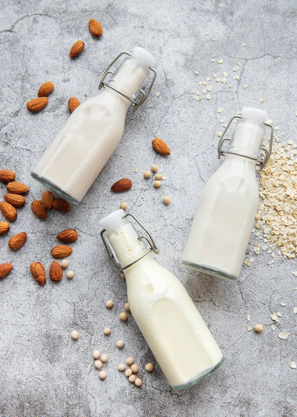 Bottles with different plant milk - soy, almond and oat milk.