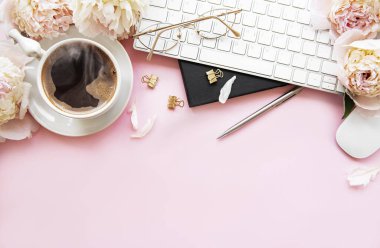 Düz manzaralı kadınlar bürosu masasında çiçeklerle yatıyordu. Dizüstü bilgisayarlı, çiçekli şakayıklı, aksesuarlı, defterli, gözlüklü, pembe arka planda bir fincan kahveli bir kadın çalışma alanı. Tatil arkaplanı. Boşluğu kopyala