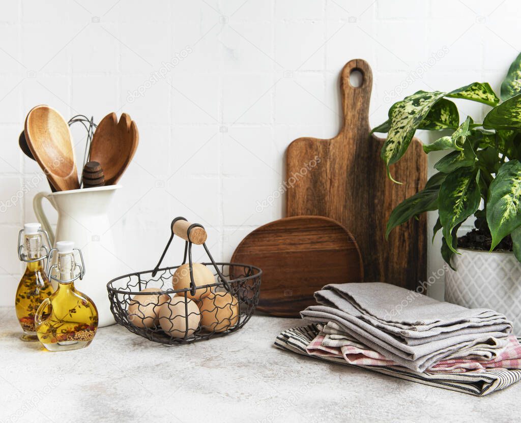 Kitchen utensils, tools and dishware on on the background white tile wall. Interior, modern kitchen space in bright colors. Blank space for a text, front view
