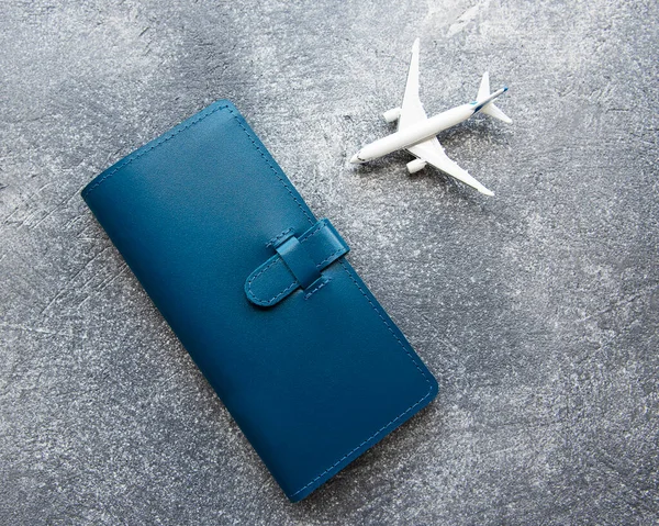 Blue leather travel purse where you can hold passport, money, boarding pass, top view, flat lay, travel accessories, documents holder, travel planning.