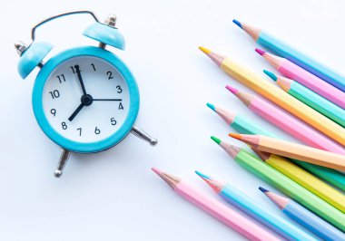 Okul konseptine geri dönelim. Beyaz arkaplanda renkli kalemler.