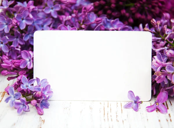 Lilac flowers with empty tag — Stock Photo, Image