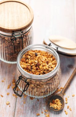 Glass jar filled with healthy granola, ready for a wholesome breakfast