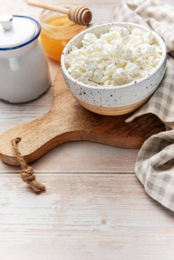 Tahtaya bal sürülmüş taze süzme peynir kasesi.