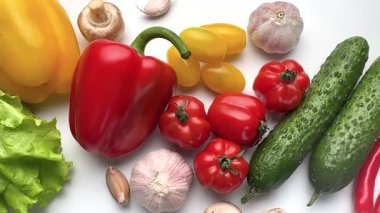Beyaz arka planda dönen taze organik sebzelerin çeşitliliği sağlıklı bir diyet için mükemmel.