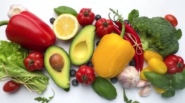 Colorful selection of fresh vegetables and fruits for healthy eating on a clean white background