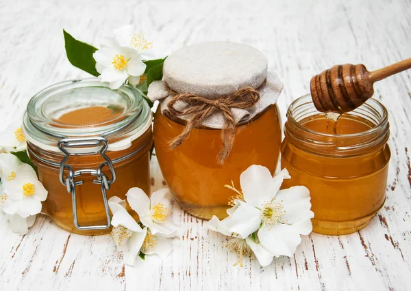 Honey with jasmine flowers — Stock Photo, Image