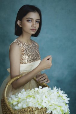 Çiçekli ve yeşil geçmişi olan güzel bir genç kız portresi..