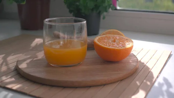 A glass of orange juice next to a cup of coffee — Stock Photo, Image