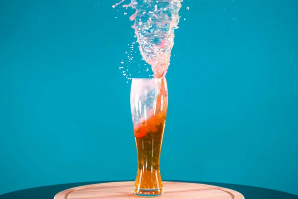 Beer in tall glass goblet on blue background with copy space — Stock Photo, Image