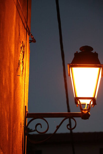Closeup view on an old street lantern against night sky