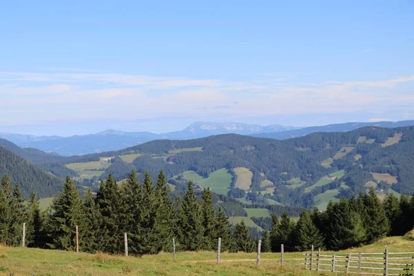 View on a mountain landscape with wooden fence in foreground