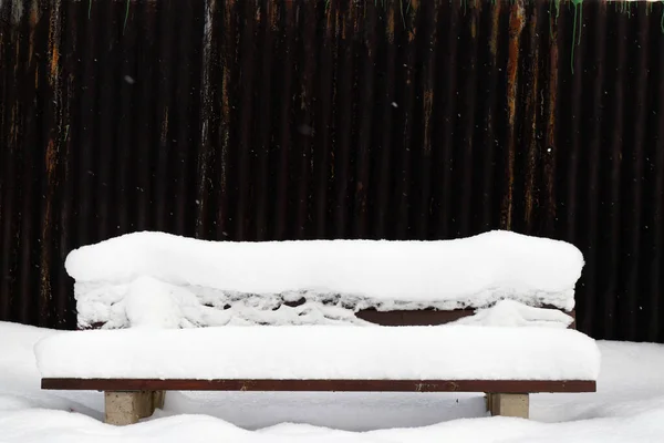 View on a snow-covered bench in winter