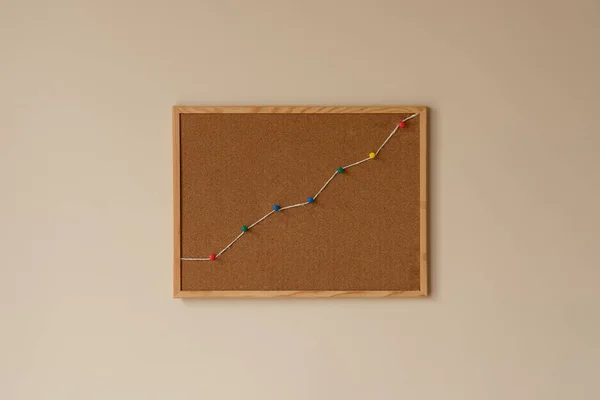 increase graph, summit, peak, top. decrease development market growth financial chart productivity data. concept of progress report. cork board, colorful pins and rope, string, copy space.