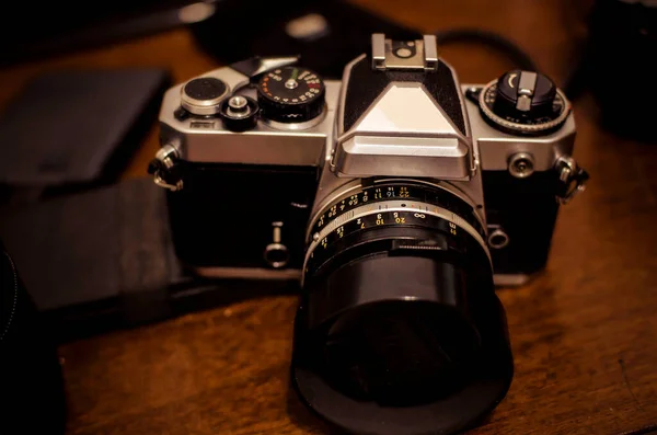 SLR analog camera on a messy tabl