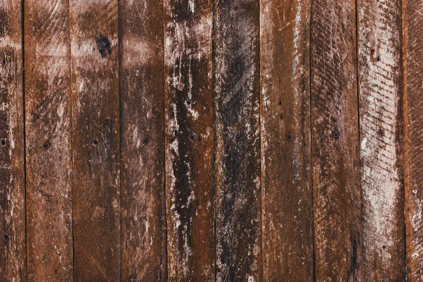 Hnědé staré dřevěné plot pozadí. Textura starých desek — Stock fotografie