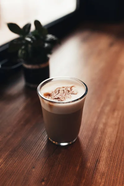 Secangkir kopi di meja di kafe dekat jendela. Latar belakang kabur — Stok Foto