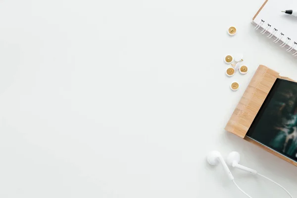 Office work, education flat lay concept with phone, headphones on the white background. High quality photo