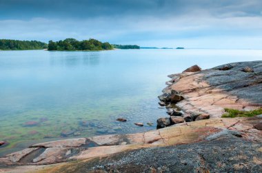 Red granite shore in the Aland Islands. Finland clipart