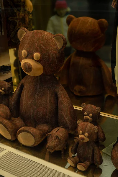 On the window are three teddy bears and a small pig piggy bank