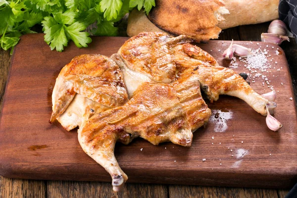 Fried chicken on chopped board.
