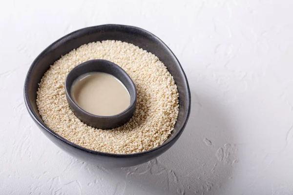 Tahini Sauce Sesame Seeds Black Bowls White Background Natural Paste — Stock Photo, Image