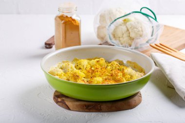 Turmeric and coconut milk baked cauliflower, vegetable recipe. Vegetarian or vegan diet, healthy food concept.