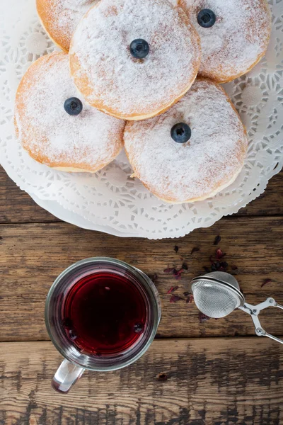 Sugary donuts and hibiscus red tea — Stock Photo, Image