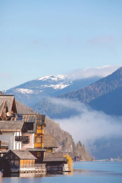 Hallstatt village on the bank of Hallstatter lake in High Alps mountains. Picturesque sunrise dawn scenery with glowing sun. Spring season. UNESCO world heritage site.