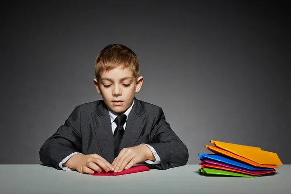 Boy in suit making paper planes — Stock Photo, Image