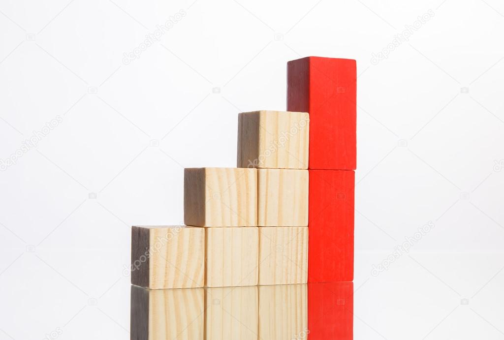 wooden blocks in stairs with red ones showing growth