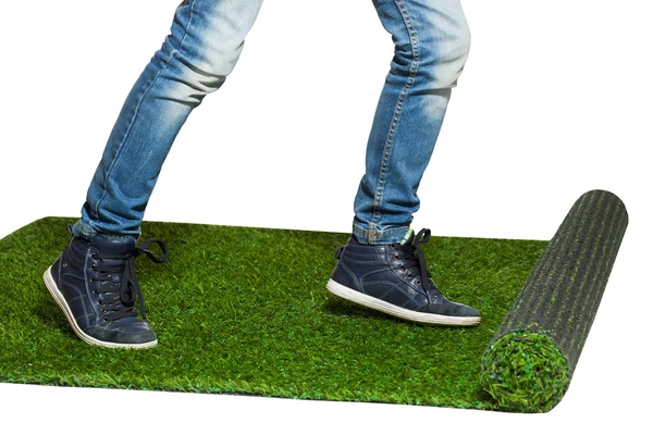 Human legs stepping on artificial grass close up isolated on whi — Stock Photo, Image